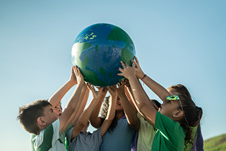 Kids holding up globe