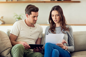 Couple at home researching options